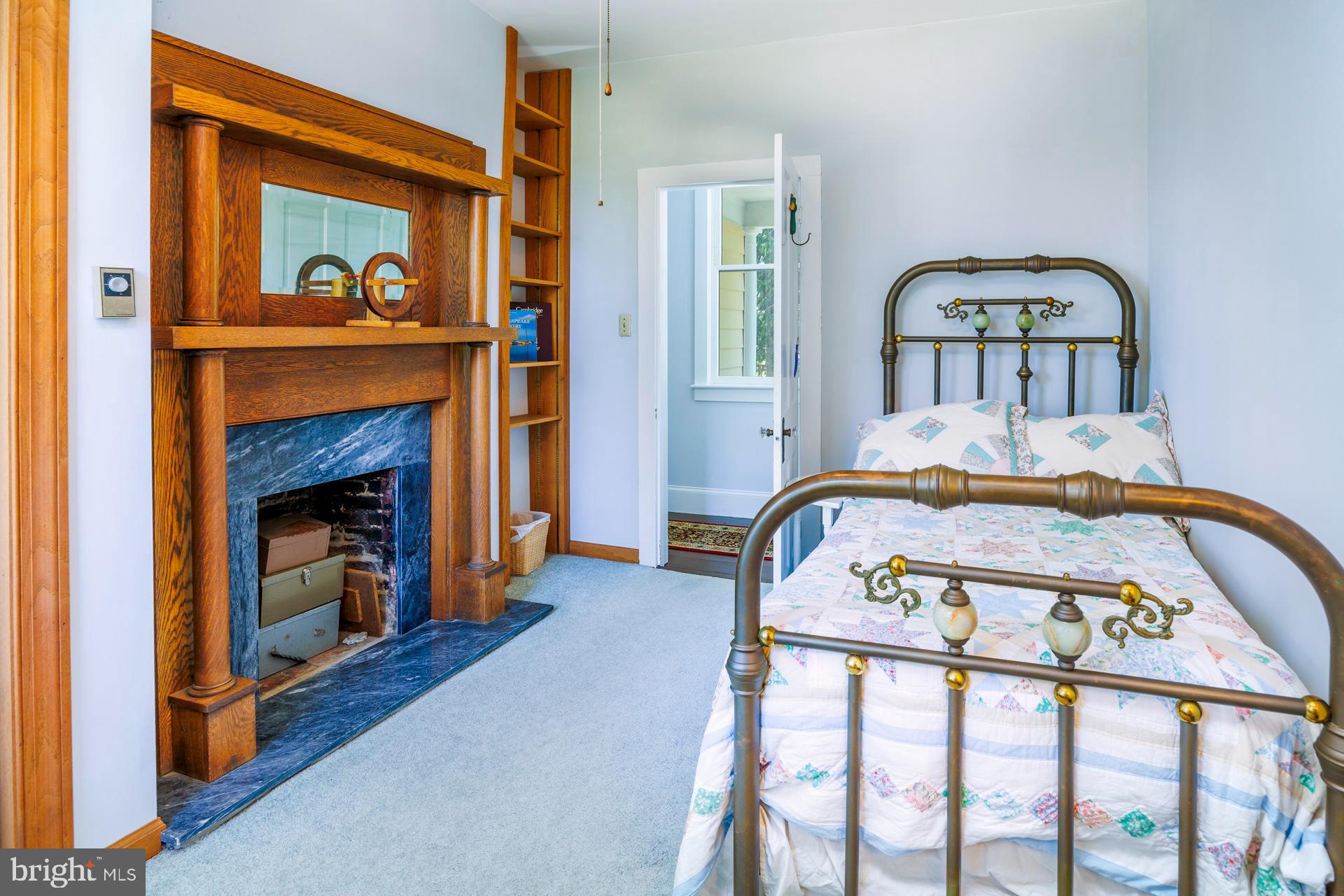 2208 Horns Point Road Cambridge, MD 21613 - Photo 47 of 61 a bedroom with a bed and a fireplace