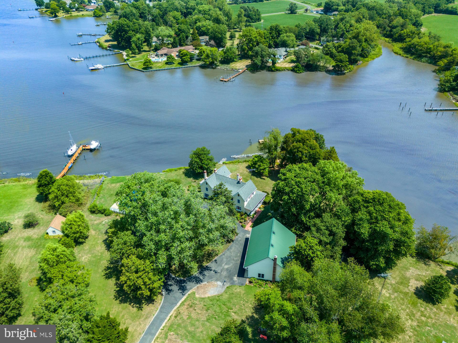 2208 Horns Point Road Cambridge, MD 21613 - Photo 5 of 61 an aerial view of a house with a yard and lake view