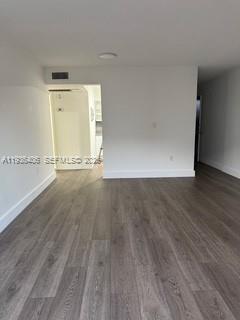 2460 Southwest 18th Avenue, Unit 1211 Miami, FL 33133 - Photo 5 of 15 an empty room with wooden floor and windows
