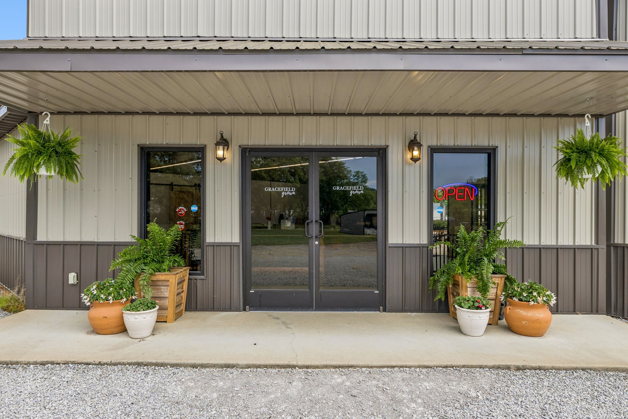 2461 Bodenham Road Pulaski, TN 38478 - Photo 23 of 100 a view of a house with potted plants and a bench