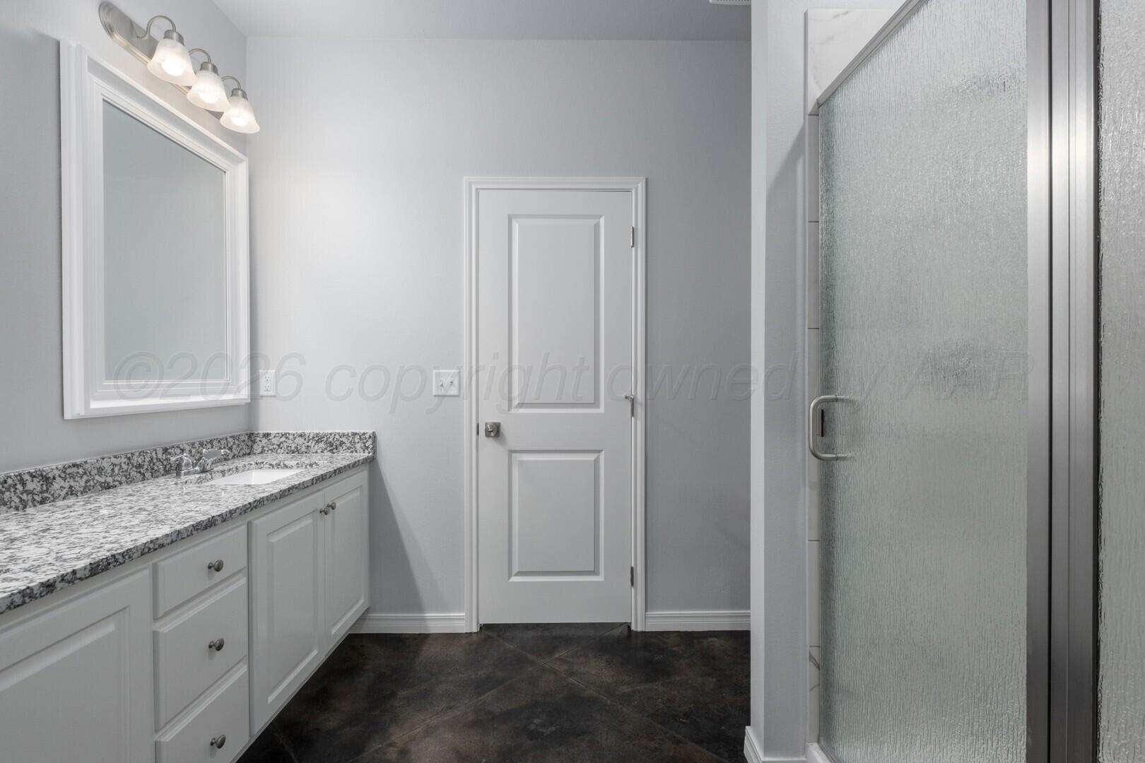 10311 Ruse Street Amarillo, TX 79118 - Photo 15 of 29 a bathroom with a granite countertop sink and a mirror