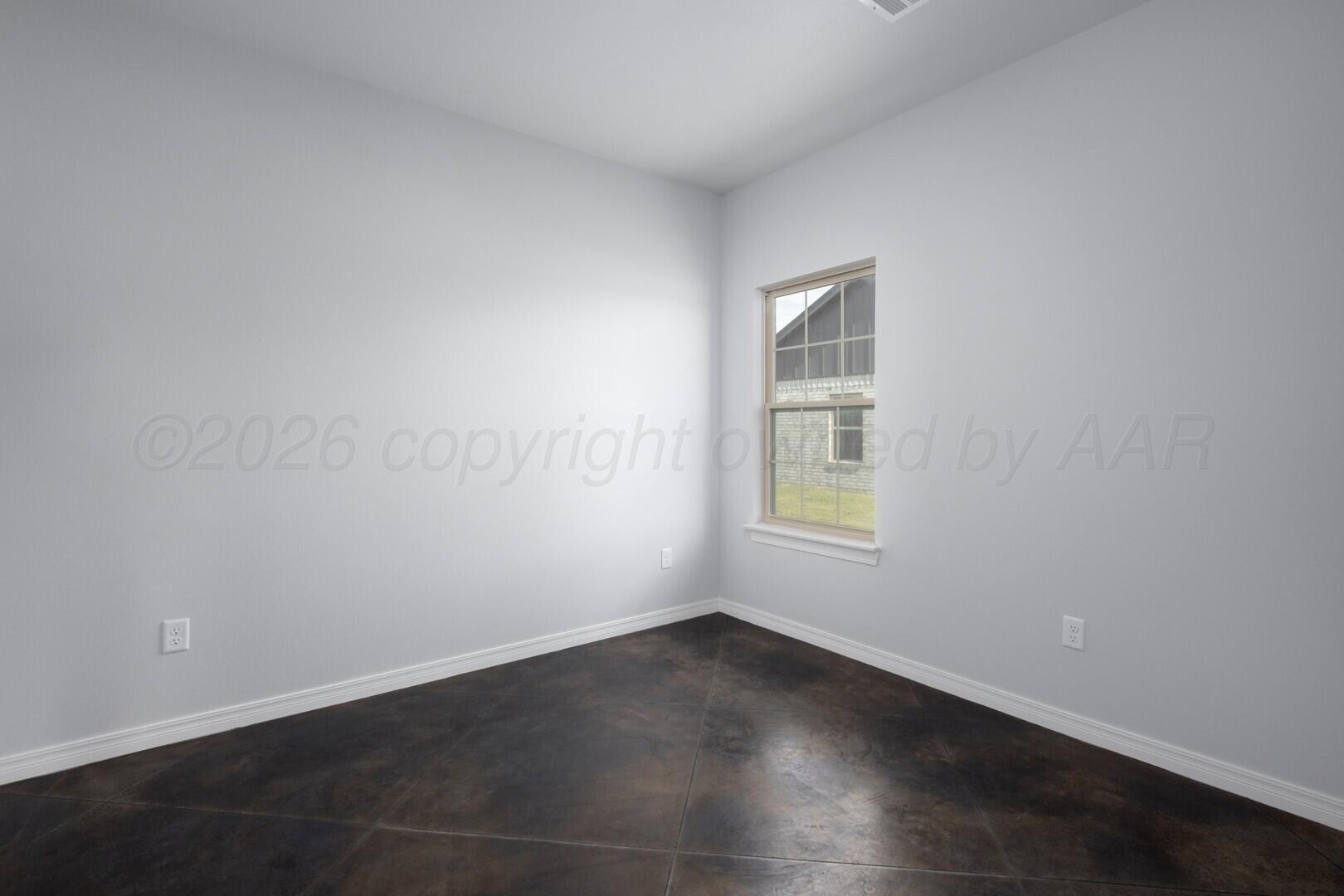 10311 Ruse Street Amarillo, TX 79118 - Photo 20 of 29 an empty room with wooden floor and windows