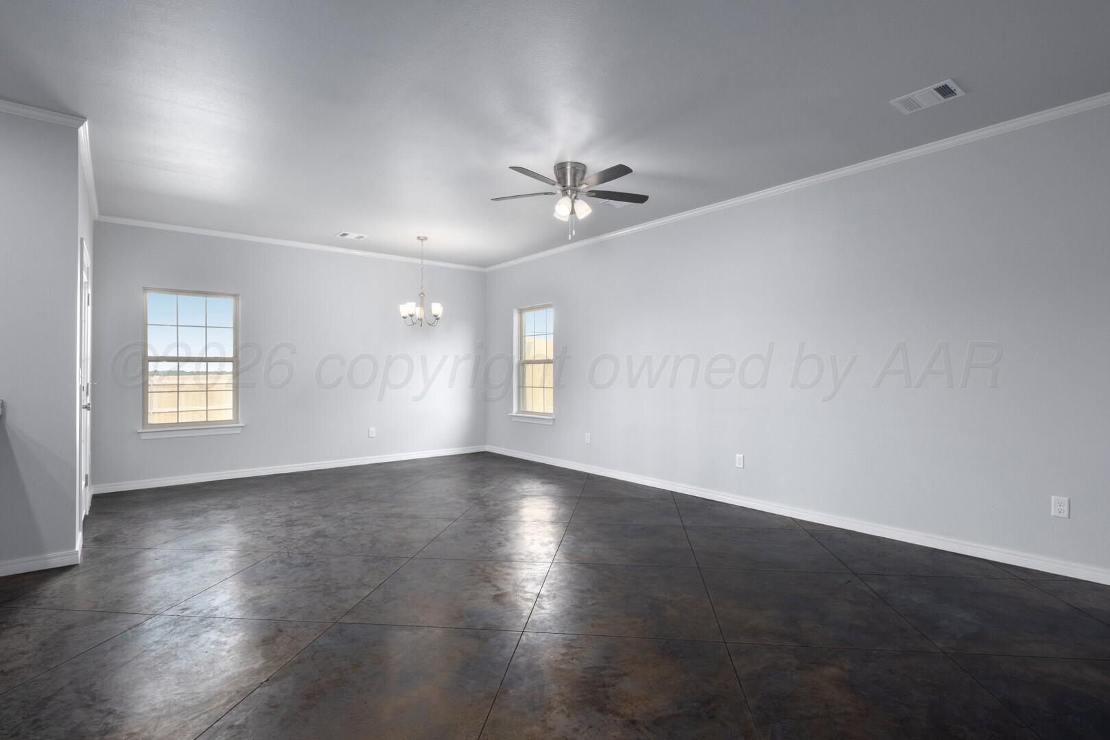 10311 Ruse Street Amarillo, TX 79118 - Photo 7 of 29 an empty room with wooden floor ceiling fan and windows