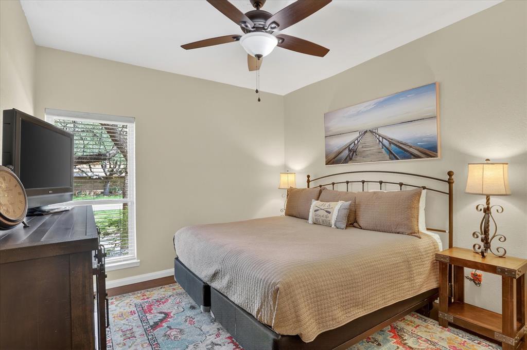8877 Random Road Fort Worth, TX 76179 - Photo 18 of 40 a bedroom with a bed and a flat screen tv