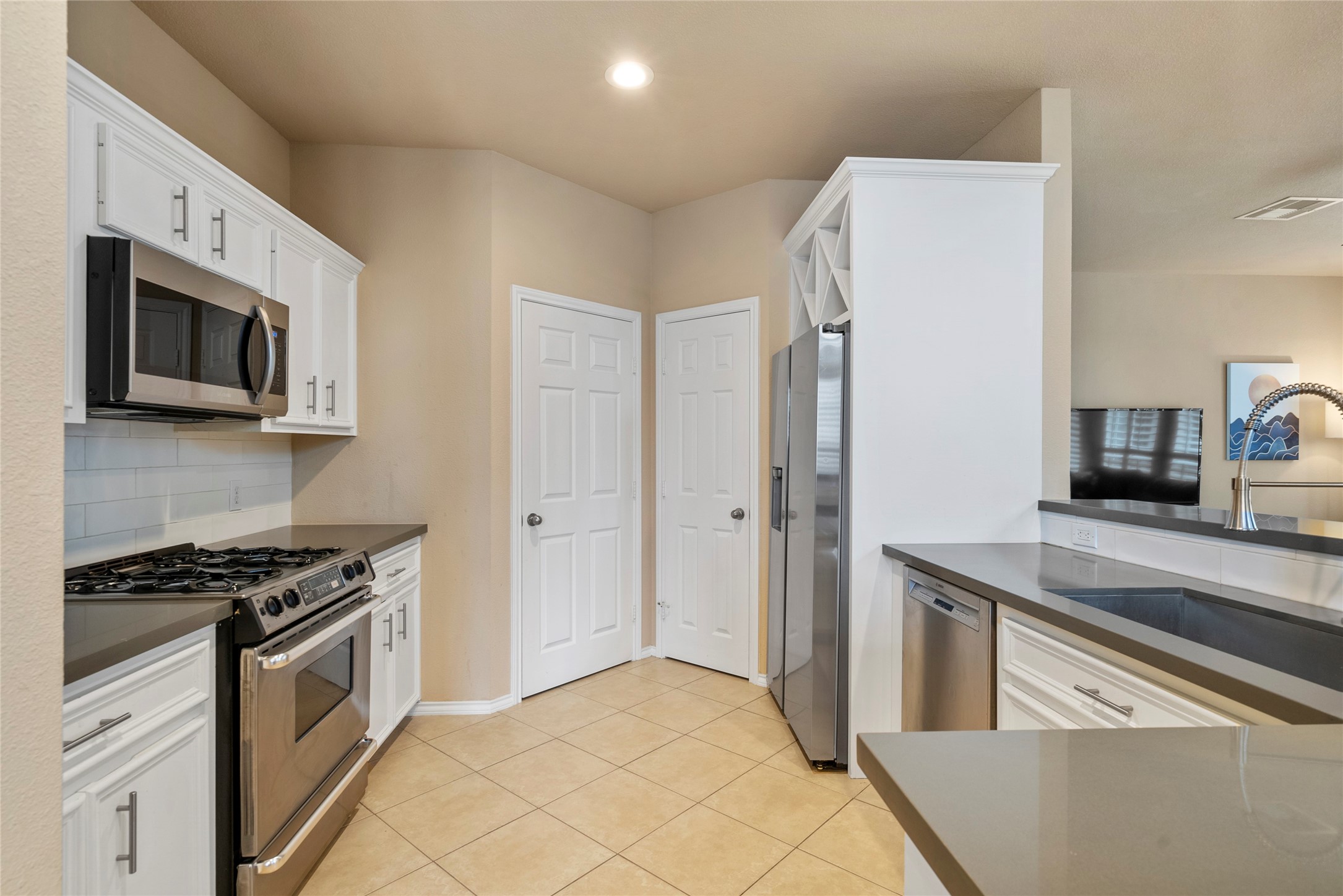 5239 Schuler Street, Unit C Houston, TX 77007 - Photo 6 of 16 a kitchen with stainless steel appliances a refrigerator stove and sink