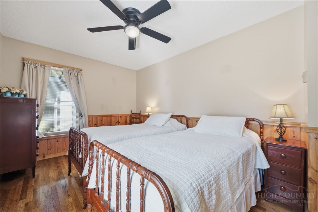 83 Pine Ridge Loop Newland, NC 28657 - Photo 11 of 32 a bed room with a bed and a chandelier