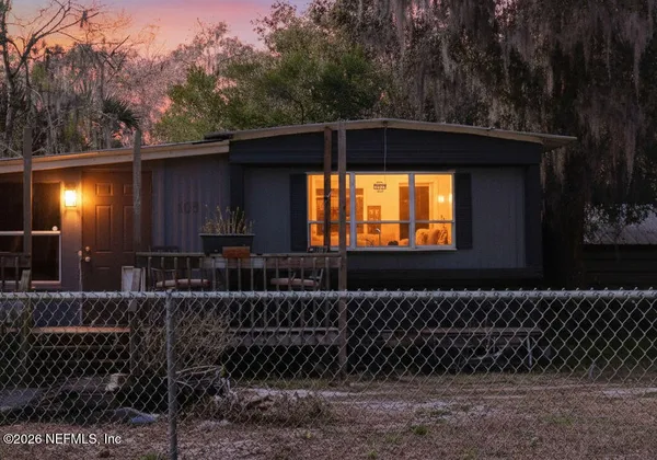 a side view of a house with a small yard