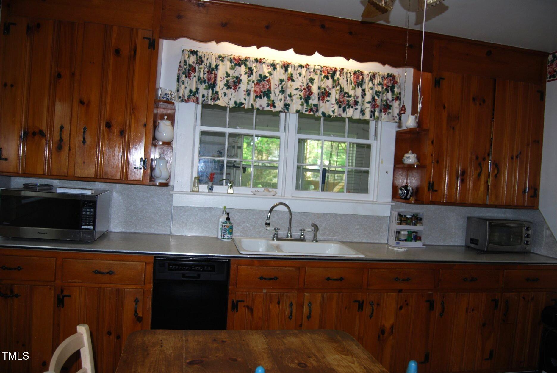 1013 Green Street Durham, NC 27701 - Photo 12 of 32 a kitchen with stainless steel appliances a sink dishwasher a refrigerator and cabinets with wooden floor