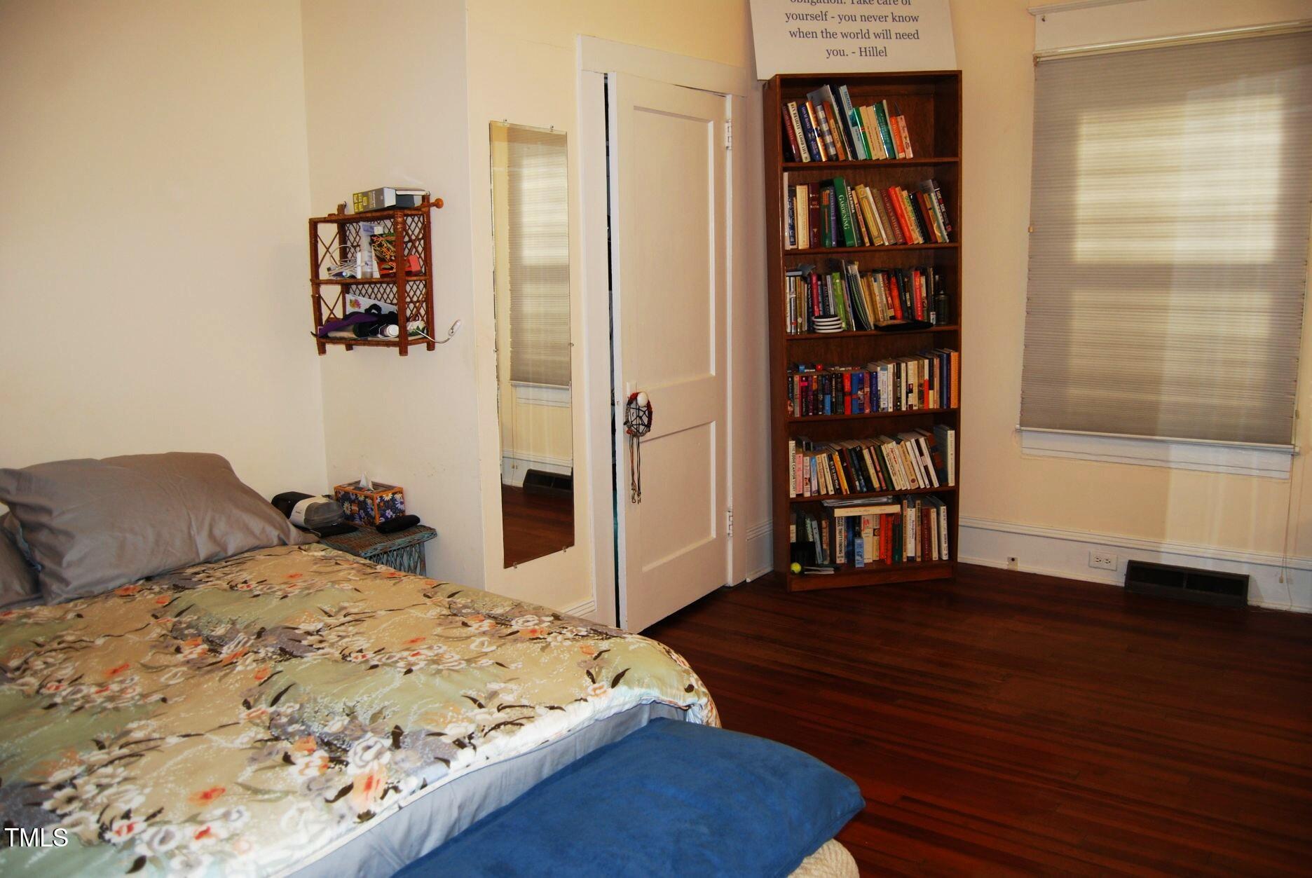 1013 Green Street Durham, NC 27701 - Photo 13 of 32 a bedroom with a bed and a book shelf