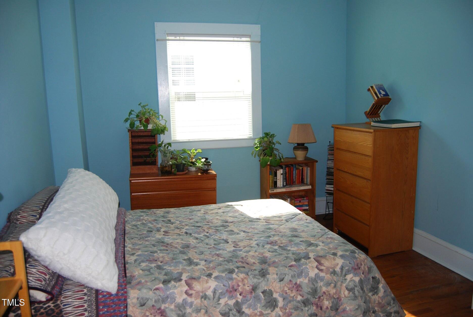 1013 Green Street Durham, NC 27701 - Photo 14 of 32 a bed sitting in a bedroom next to a window