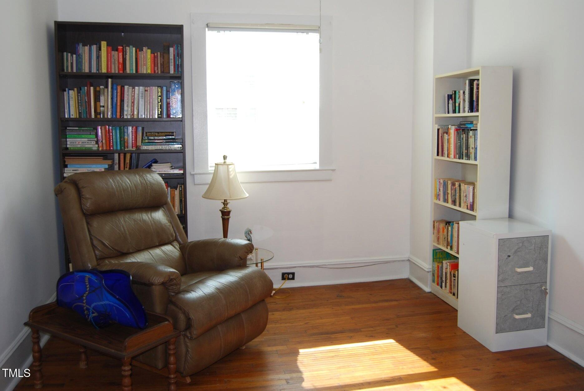 1013 Green Street Durham, NC 27701 - Photo 16 of 32 a living room with furniture and a book shelf