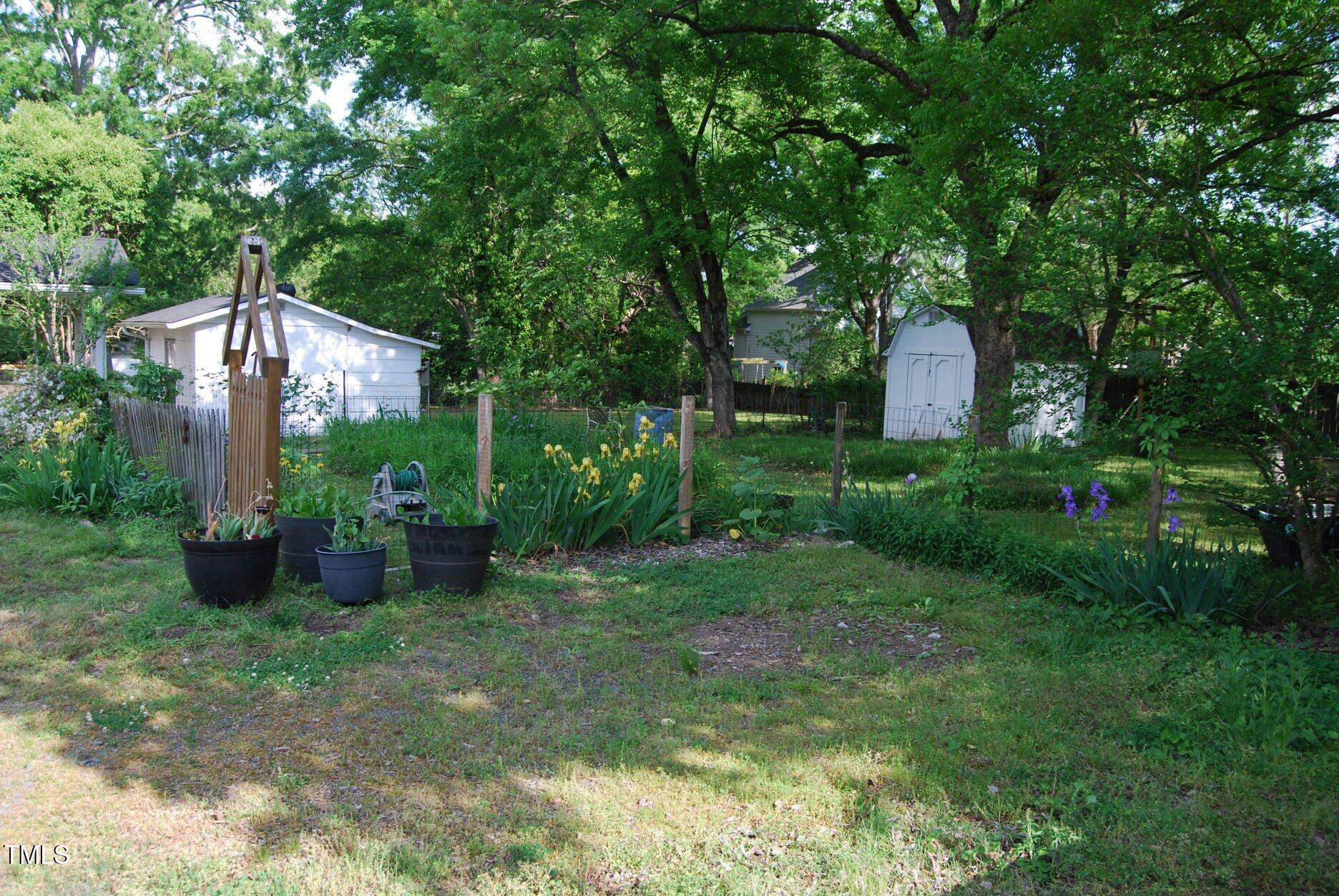 1013 Green Street Durham, NC 27701 - Photo 23 of 32 a view of a house with yard and a garden