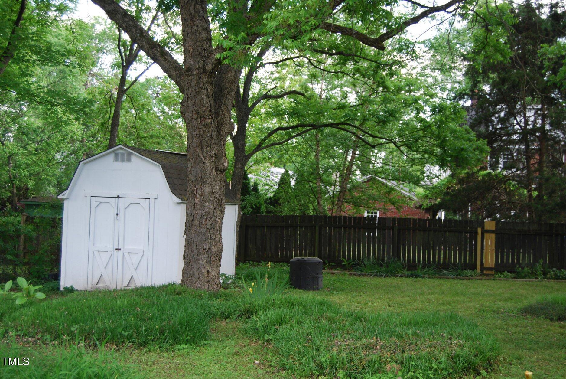 1013 Green Street Durham, NC 27701 - Photo 27 of 32 a view of backyard with large trees and wooden fence