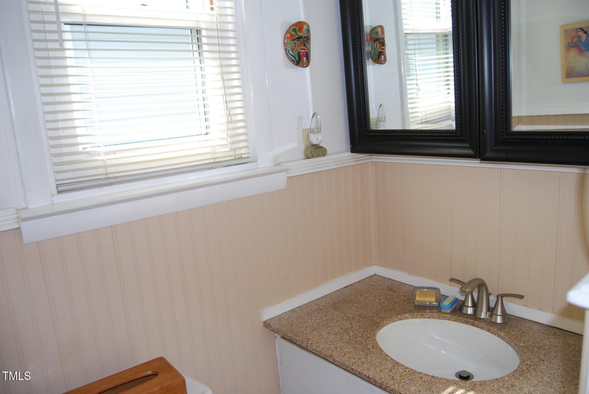 1013 Green Street Durham, NC 27701 - Photo 10 of 32 a bathroom with a granite countertop sink and a mirror