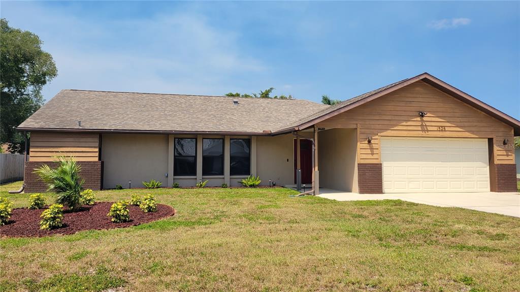 1526 Georgetowne Lane Sarasota, FL 34232 - Photo 1 of 21 a front view of a house with a garden and yard