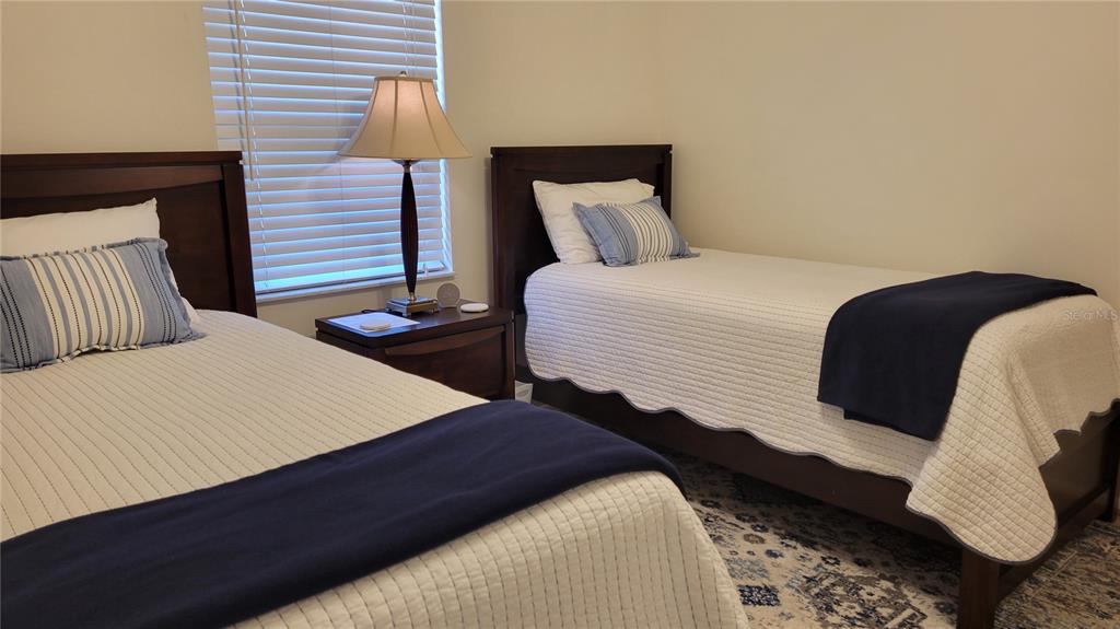 1526 Georgetowne Lane Sarasota, FL 34232 - Photo 14 of 21 a bedroom with double bed and a night stand