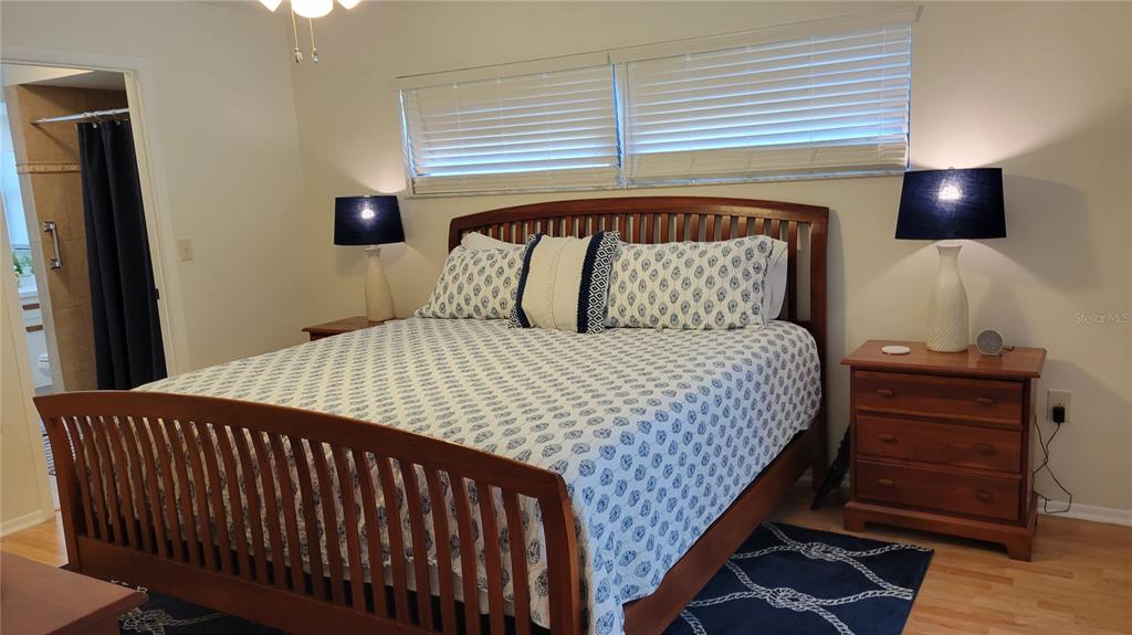 1526 Georgetowne Lane Sarasota, FL 34232 - Photo 16 of 21 a bedroom with a bed and wooden floor