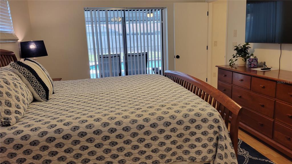 1526 Georgetowne Lane Sarasota, FL 34232 - Photo 18 of 21 a bedroom with a bed and a dresser