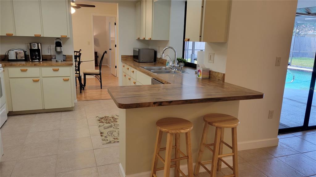 1526 Georgetowne Lane Sarasota, FL 34232 - Photo 3 of 21 a kitchen with stainless steel appliances granite countertop a sink a stove and white cabinets