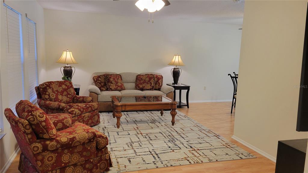 1526 Georgetowne Lane Sarasota, FL 34232 - Photo 10 of 21 a living room with furniture and a rug