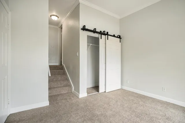 an empty room with mirror and a window