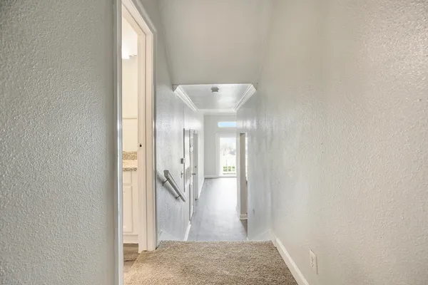 a bathroom with a granite countertop sink and a toilet