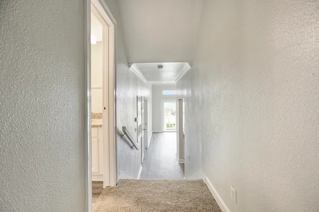 a bathroom with a granite countertop sink and a toilet