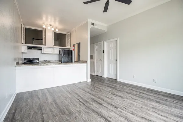 a view of a kitchen with a sink microwave and cabinets