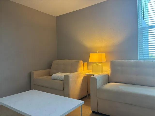 a living room with a couch and a night stand