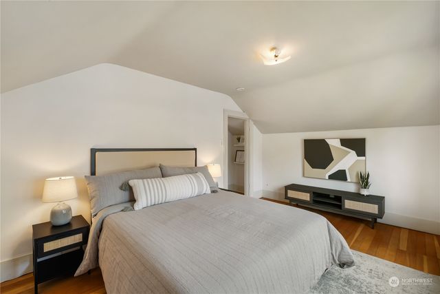 a bedroom with a bed and a lamp on table