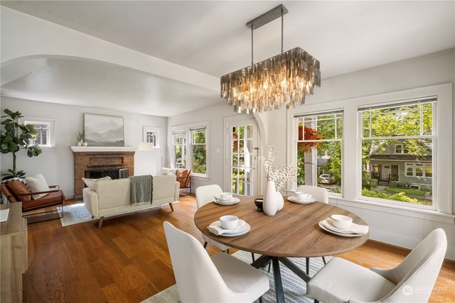 a view of a dining room with furniture wooden floor and chandelier