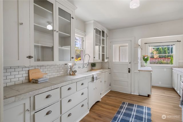 a kitchen with sink and cabinets