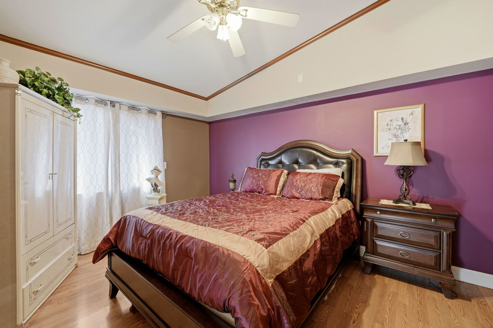 1317 North Cedar Lake Road Lake Villa, IL 60046 - Photo 2 of 25 a bedroom with a bed and a chandelier