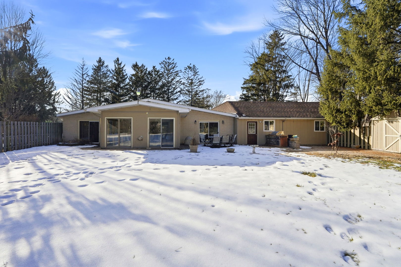 1317 North Cedar Lake Road Lake Villa, IL 60046 - Photo 24 of 25 a front view of a house with a dirt yard and a large tree