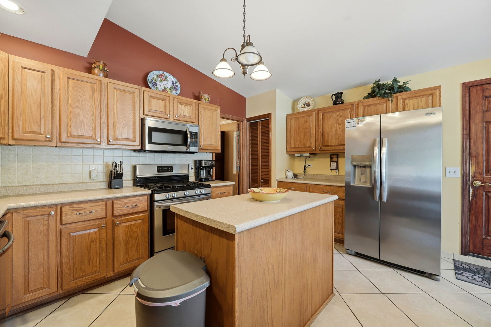 1317 North Cedar Lake Road Lake Villa, IL 60046 - Photo 10 of 25 a kitchen with a refrigerator a sink and cabinets