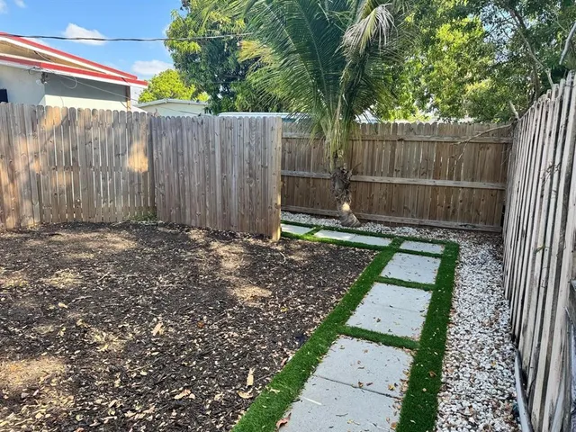 a view of a backyard with a small cabin and a chair