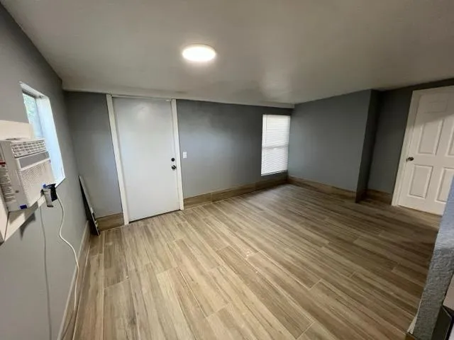 wooden floor in an empty room with a window