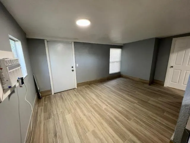 wooden floor in an empty room with a window