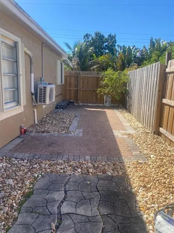 a view of a backyard with plants and trees