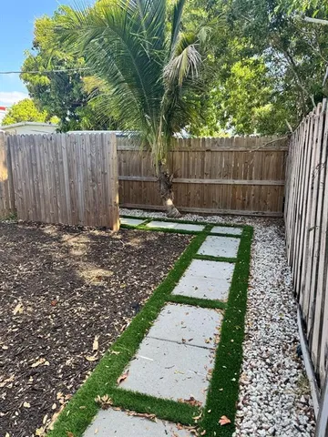 a view of yard with wooden fence