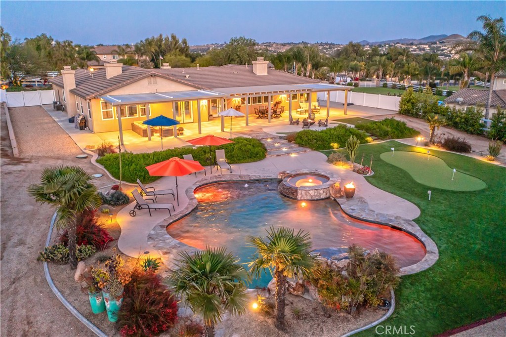an aerial view of a house with a swimming pool yard and outdoor seating