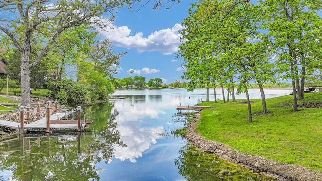 a view of an empty room with window and a fireplace