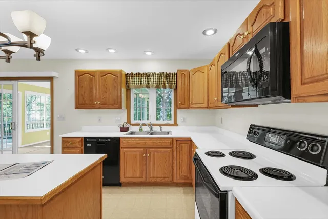 a view of an empty room with a fireplace and a window