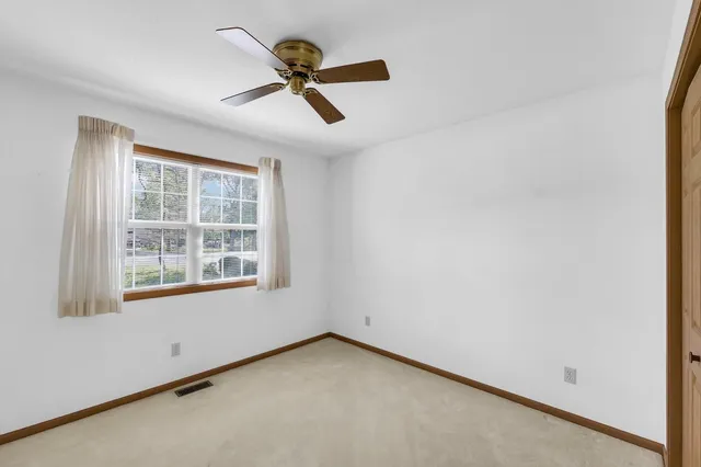 a view of a porch with a floor to ceiling window and wooden fence