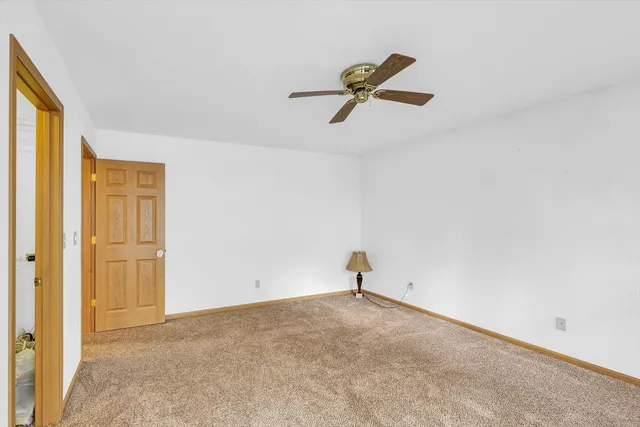 a view of a house with a yard and tree