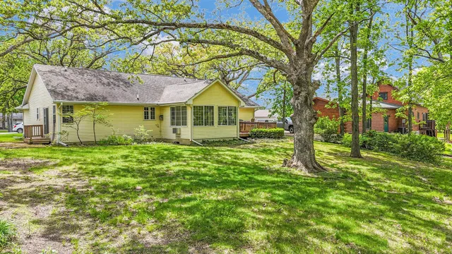 an aerial view of a house with a yard and lake view