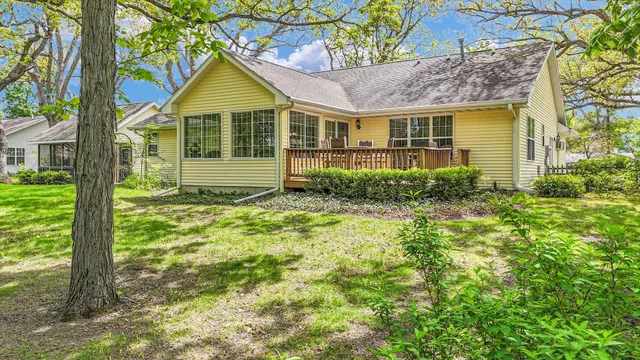 a view of a house with a yard and tree s