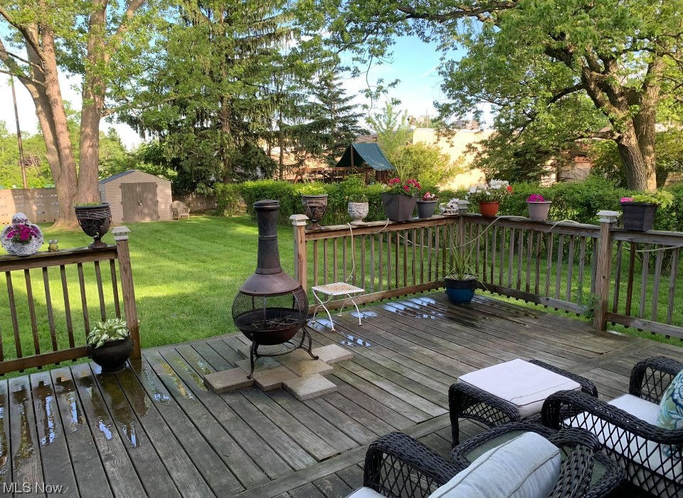 1500 Edgefield Road Lyndhurst, OH 44124 - Photo 24 of 24 Wooden deck with a yard, a storage unit, and an outdoor fire pit