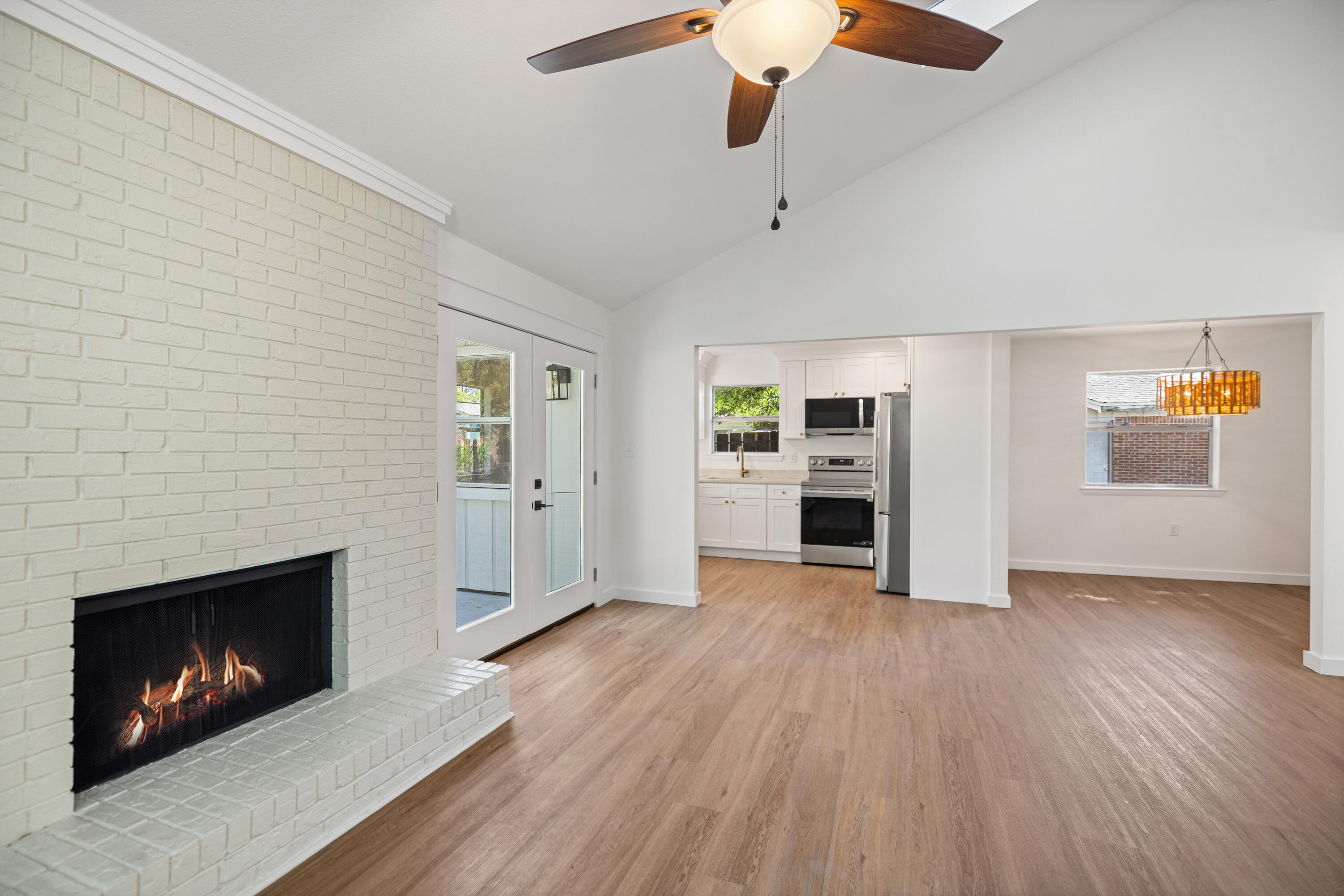 103 Perdido Circle Niceville, FL 32578 - Photo 11 of 71 an empty room with a fireplace and wooden floor