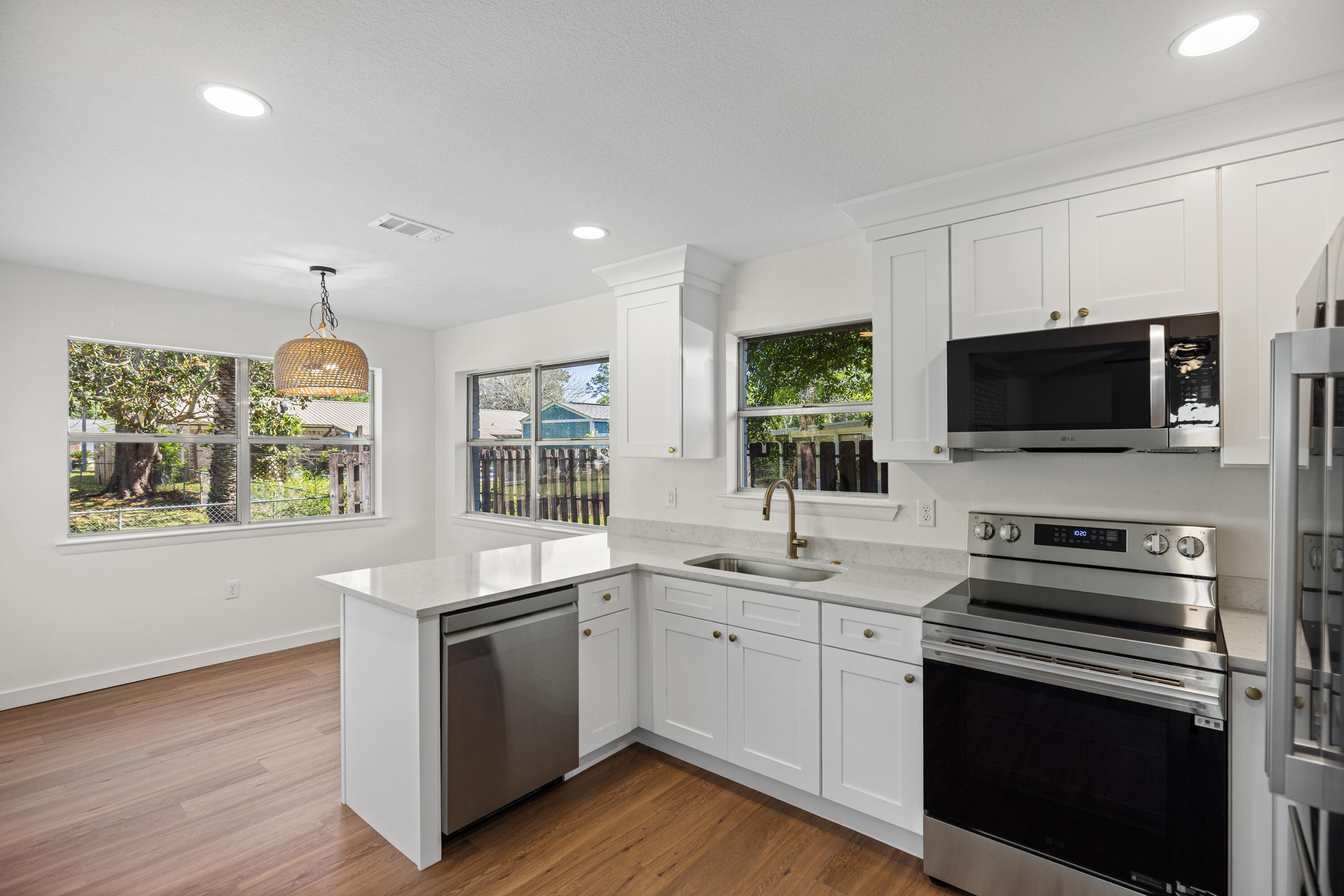 103 Perdido Circle Niceville, FL 32578 - Photo 19 of 71 a kitchen with a sink stove oven and microwave